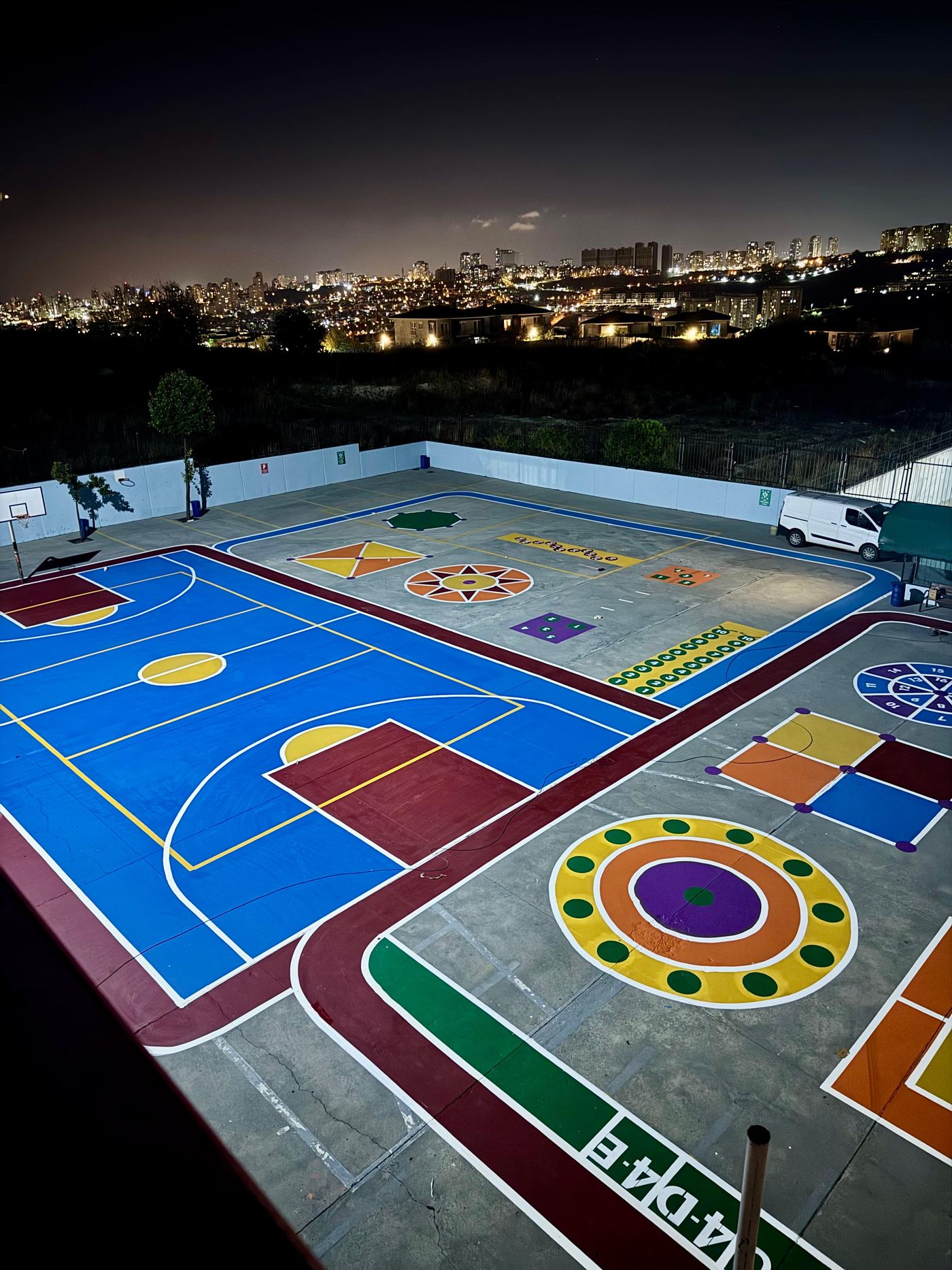 Gece aydınlatmasında renkli zeminli çok amaçlı spor sahası ve oyun alanı çizimleri